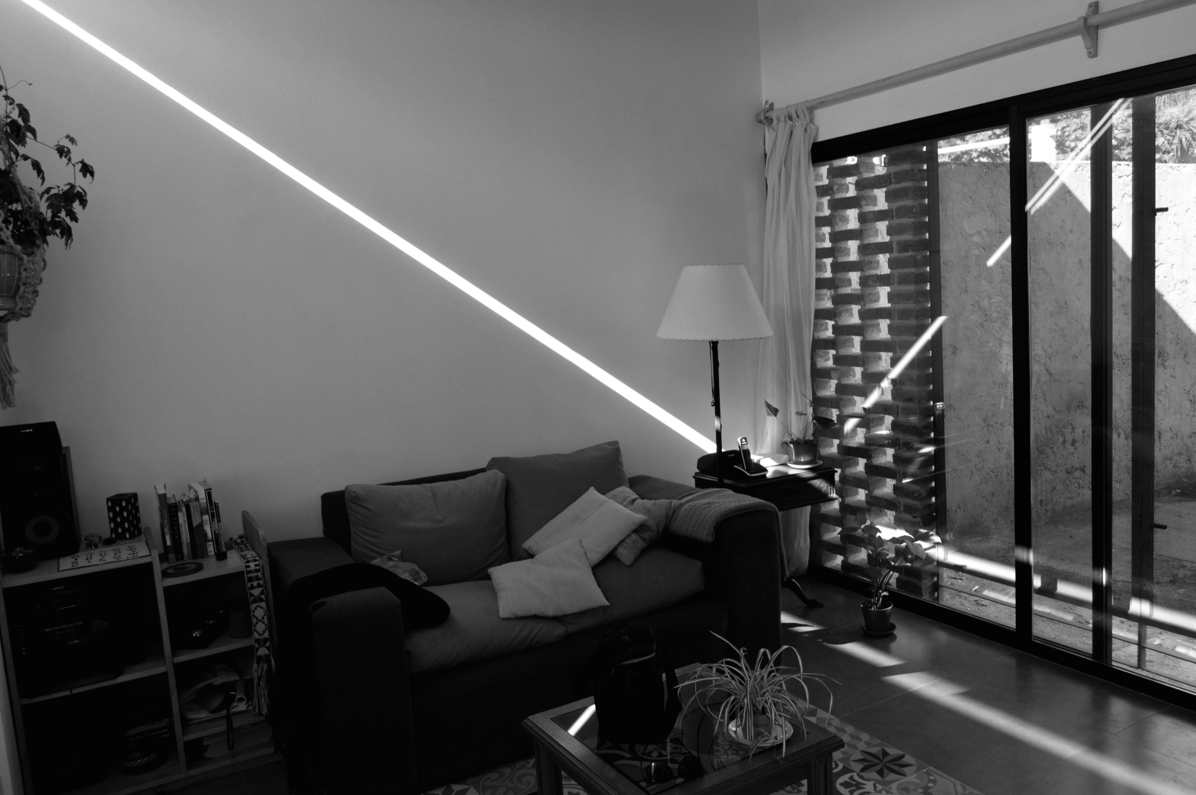Estar de Casa Malvi atravesado por una línea de luz